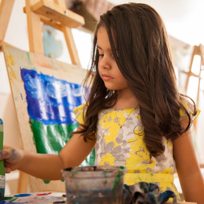 A young girl paints.