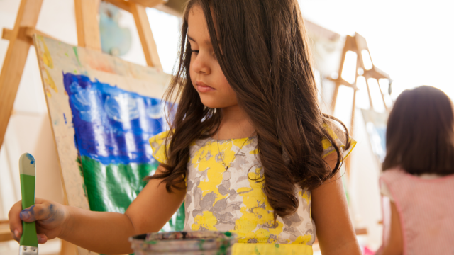 A young girl paints.