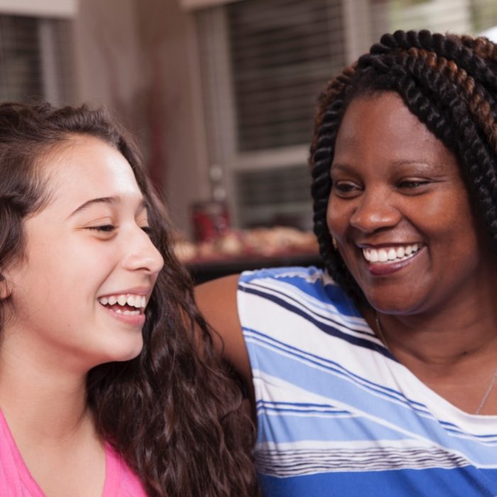 A woman laughs with her foster child.